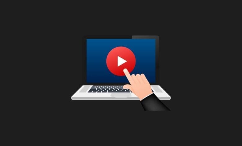 a finger pointing at a button on a laptop