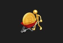 a gold figure pushing a wheelbarrow with a bitcoin coin