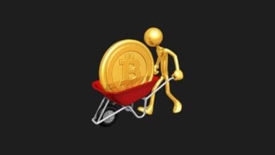 a gold figure pushing a wheelbarrow with a bitcoin coin