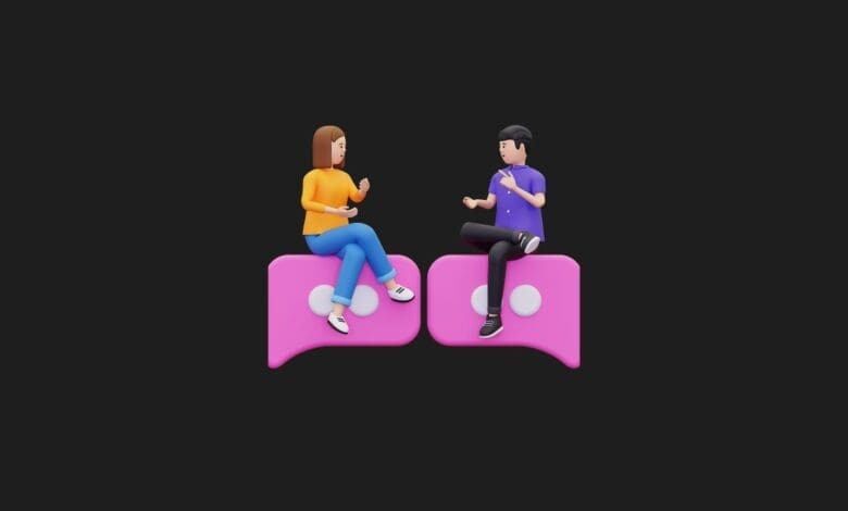 a couple of people sitting on a pink chat bubble