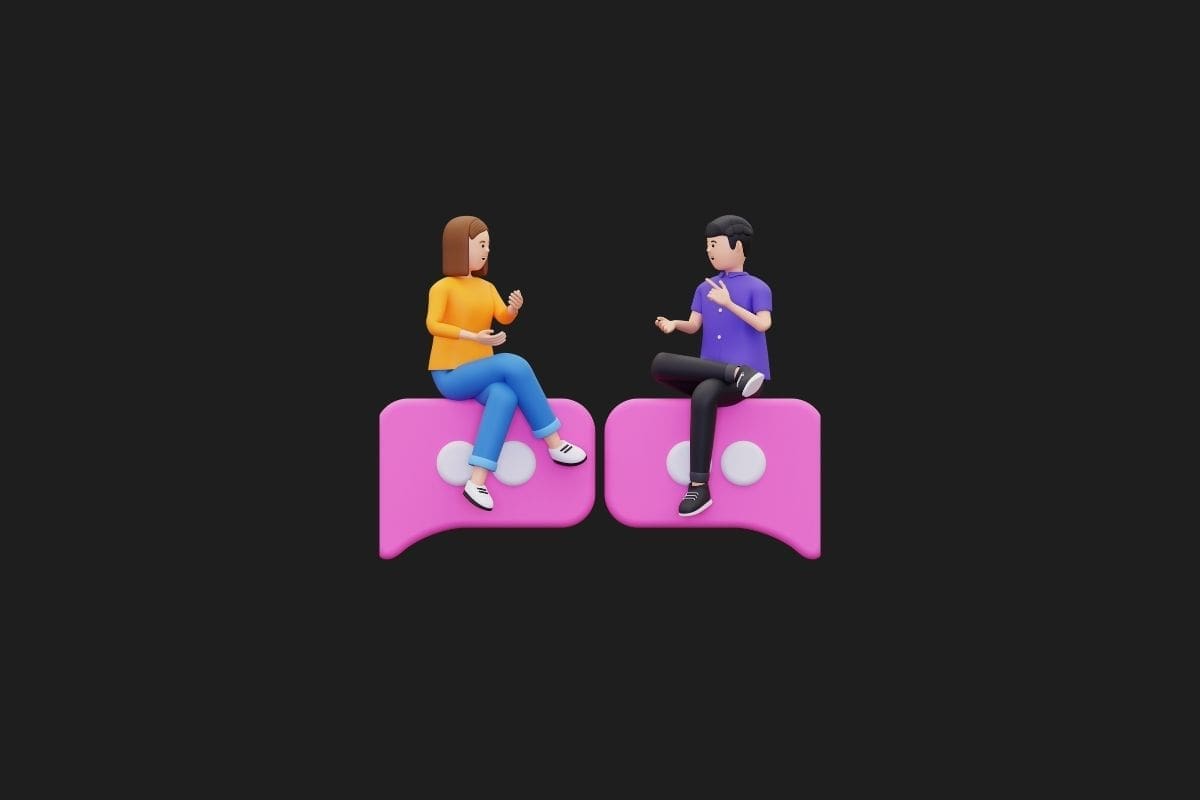 a couple of people sitting on a pink chat bubble